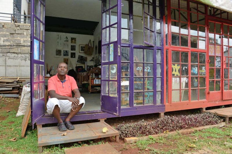 Peterson Kamwathi sits outside his studio at the GoDown Arts Centre in Nairobi. | Image: WAKILISHA