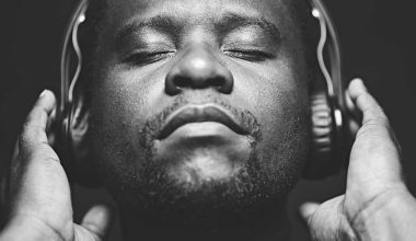 African Man wearing headphones while listening to music
