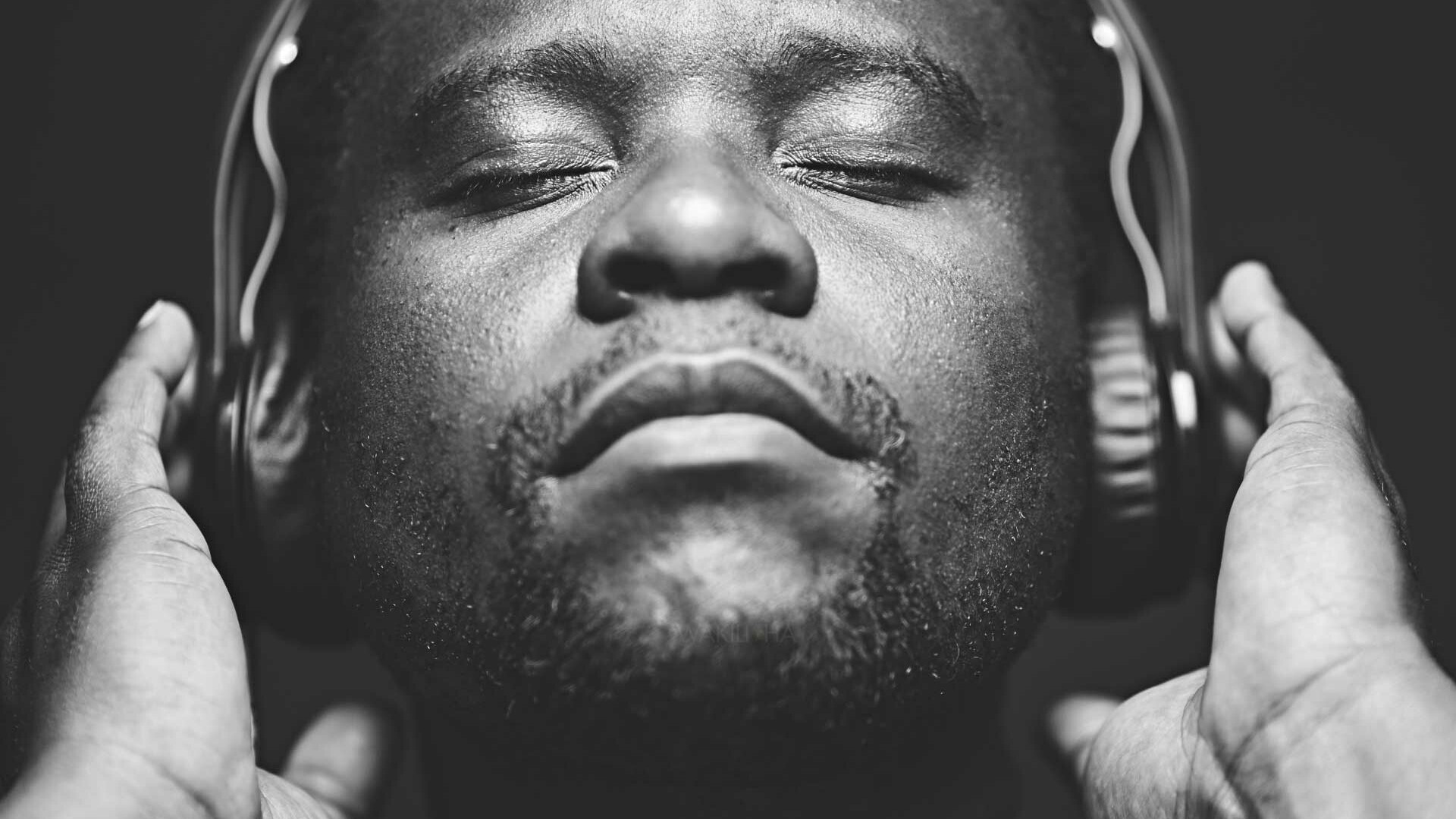 African Man wearing headphones while listening to music