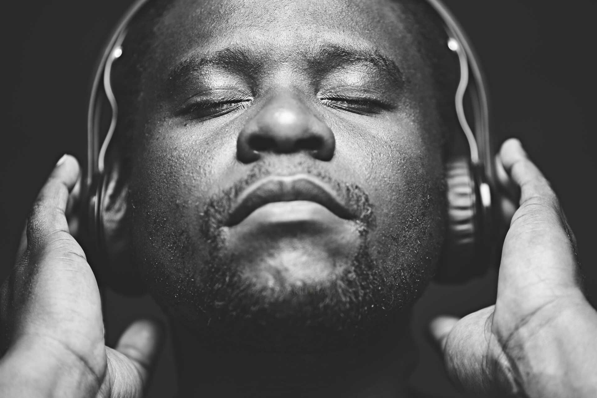 African Man wearing headphones while listening to music