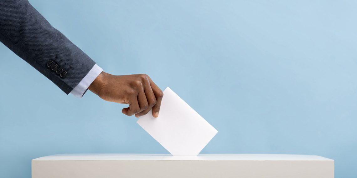 An image of an African man's hand placing a vote in a ballot box | 2022 General Elections in Kenya