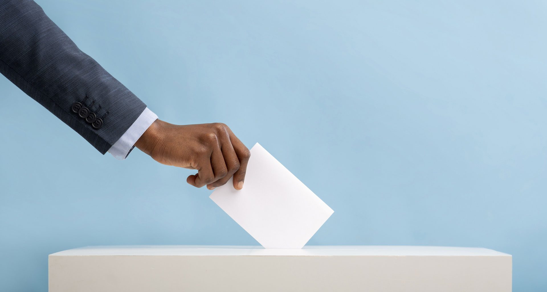 An image of an African man's hand placing a vote in a ballot box | 2022 General Elections in Kenya