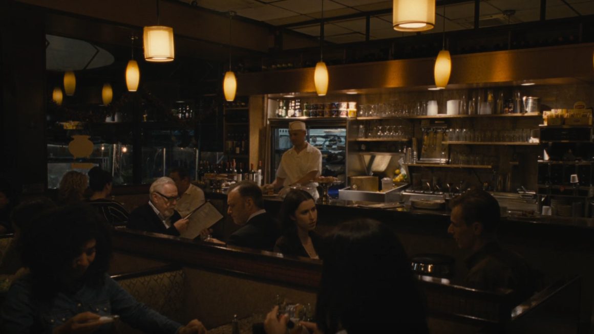 Logan Roy and his bodyguard Collins in a café. This scene is from Season 4, Episode 1 of the HBO show Succession. ~ Image: MAX